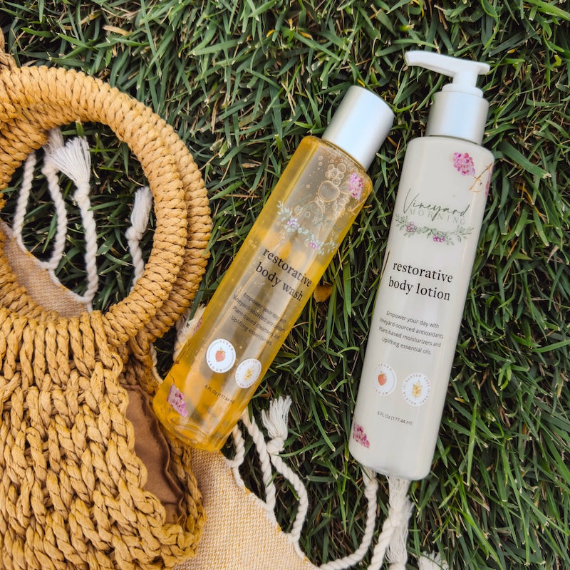 Vineyard Morning products on a picnic blanket with straw bag