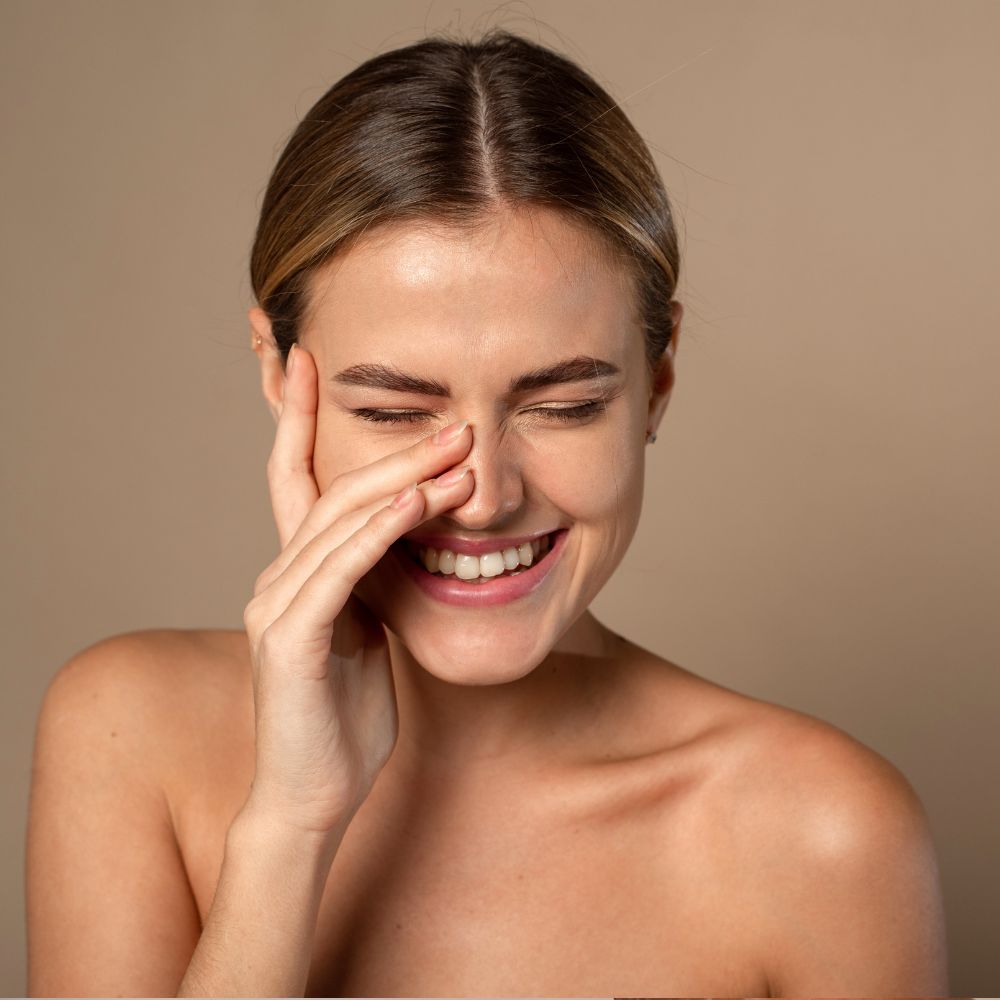 Woman applying gentle face-grade body wash in shower