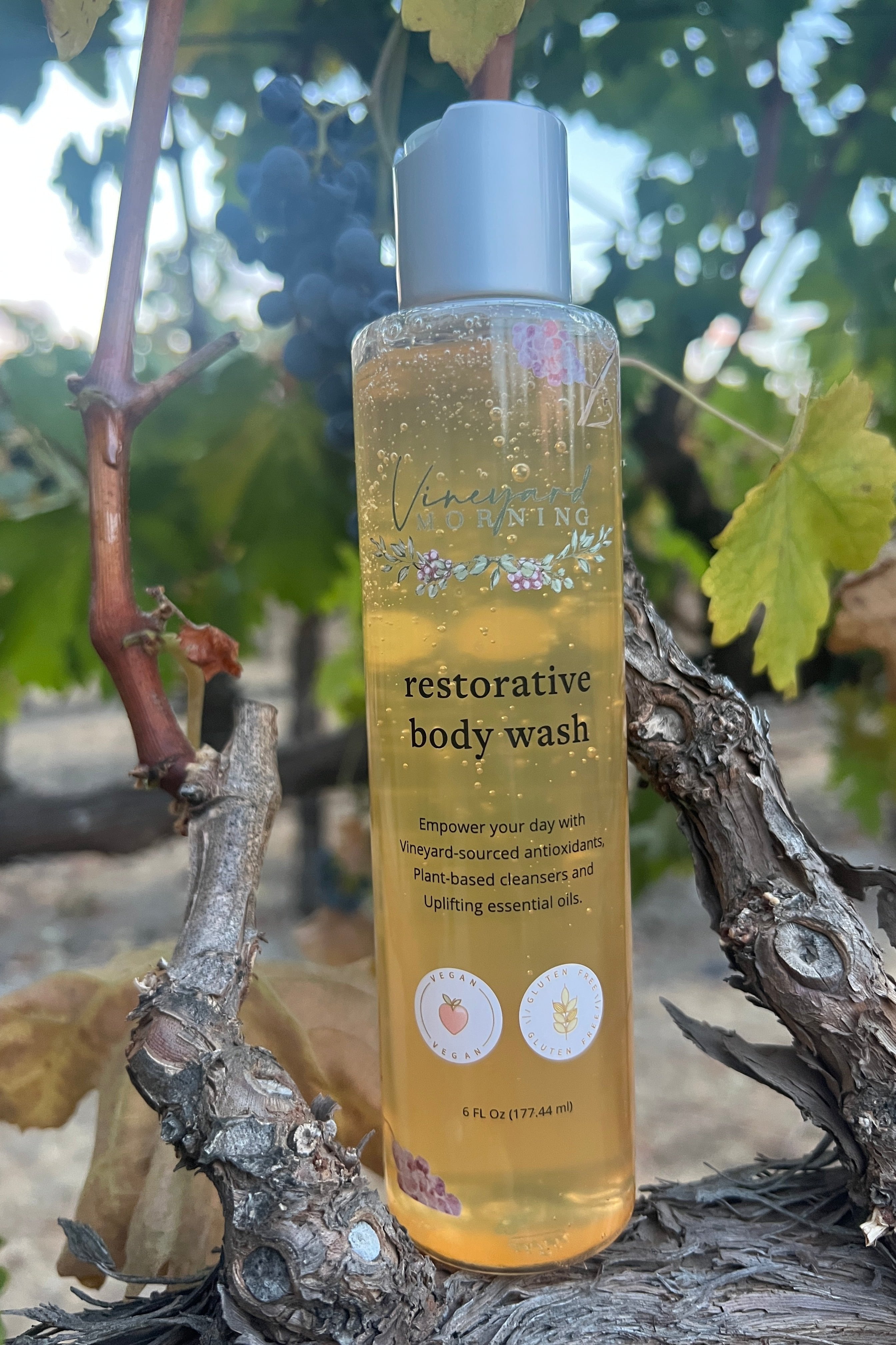 Soothing clean beauty body wash placed in vineyard